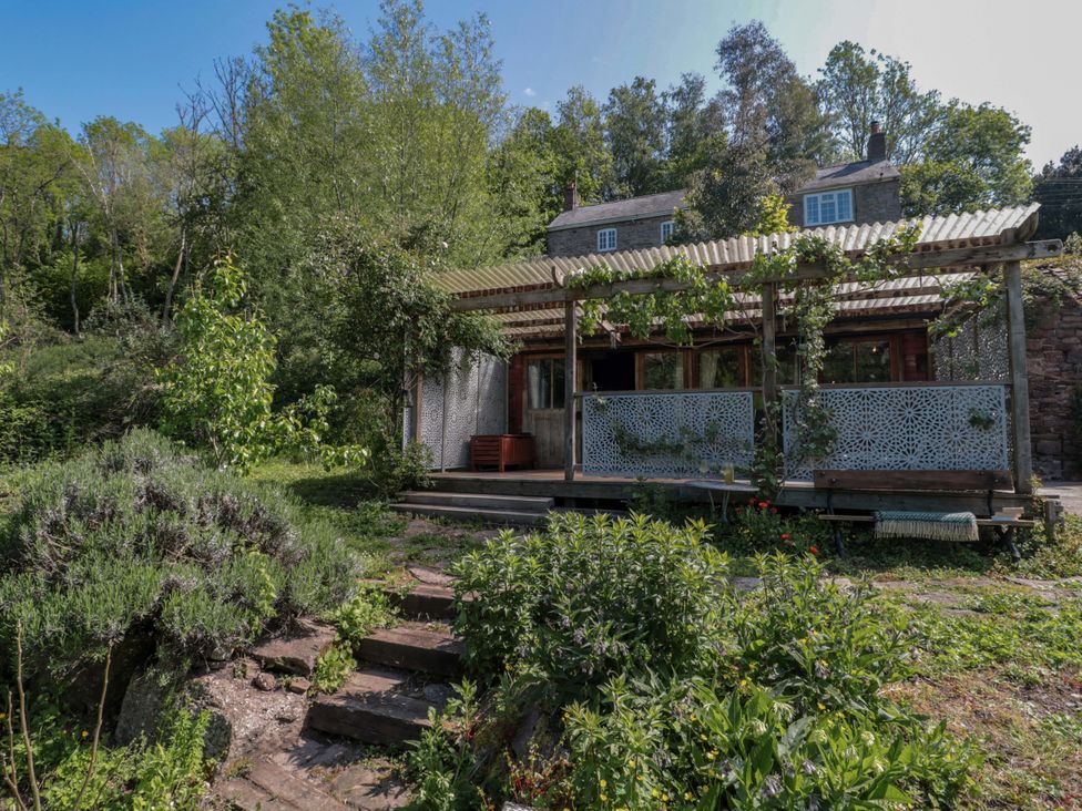 A house with a balcony and plants at Ferryman's Lodge in Brockweir