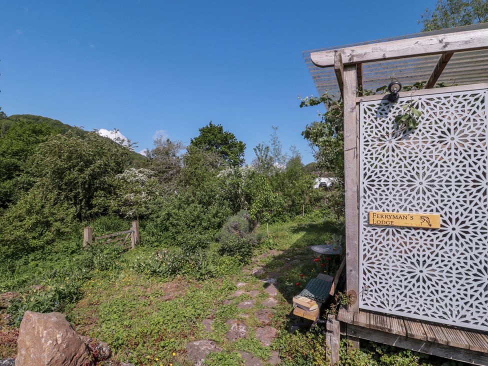 An outdoor area with a sign and a pathway at Ferryman's Lodge in Brockweir