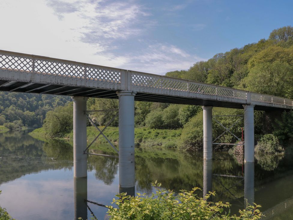 A bridge over a river in a landscape at Ferryman's Lodge in Brockweir