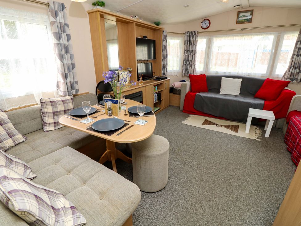 A living room with a dining table and sofa at Caravan in Cowes