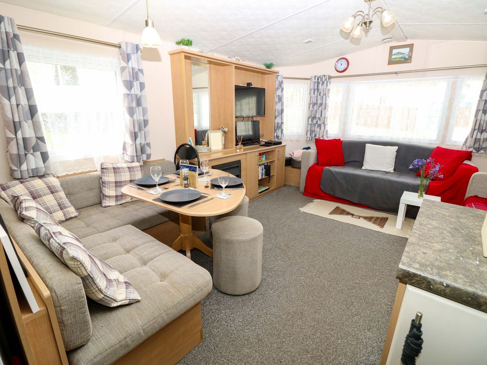 A living room with a sofa and dining table at Caravan in Cowes