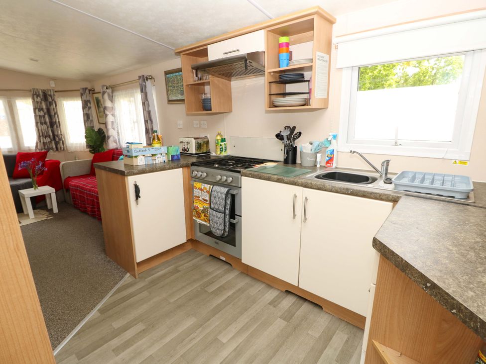 A kitchen with an oven and sink at Caravan in Cowes
