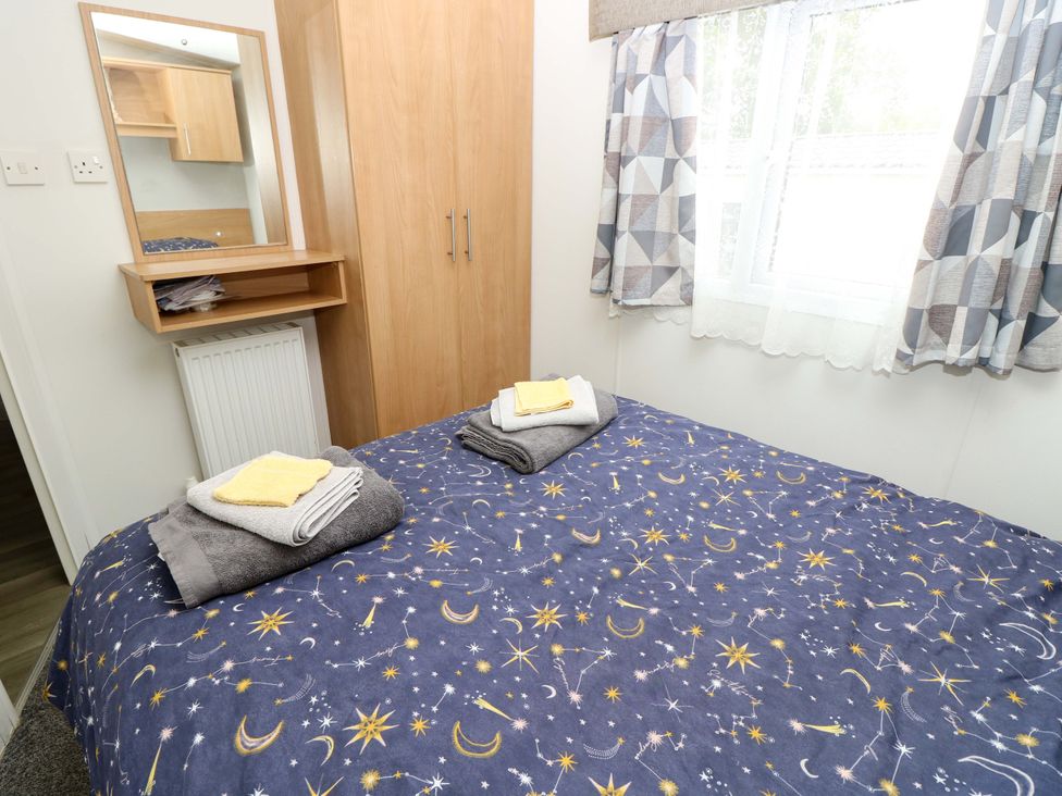 A bedroom with a bed and furniture at Caravan in Cowes