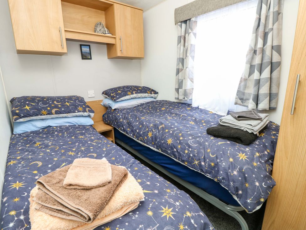 A bedroom with two beds and towels at Caravan in Cowes