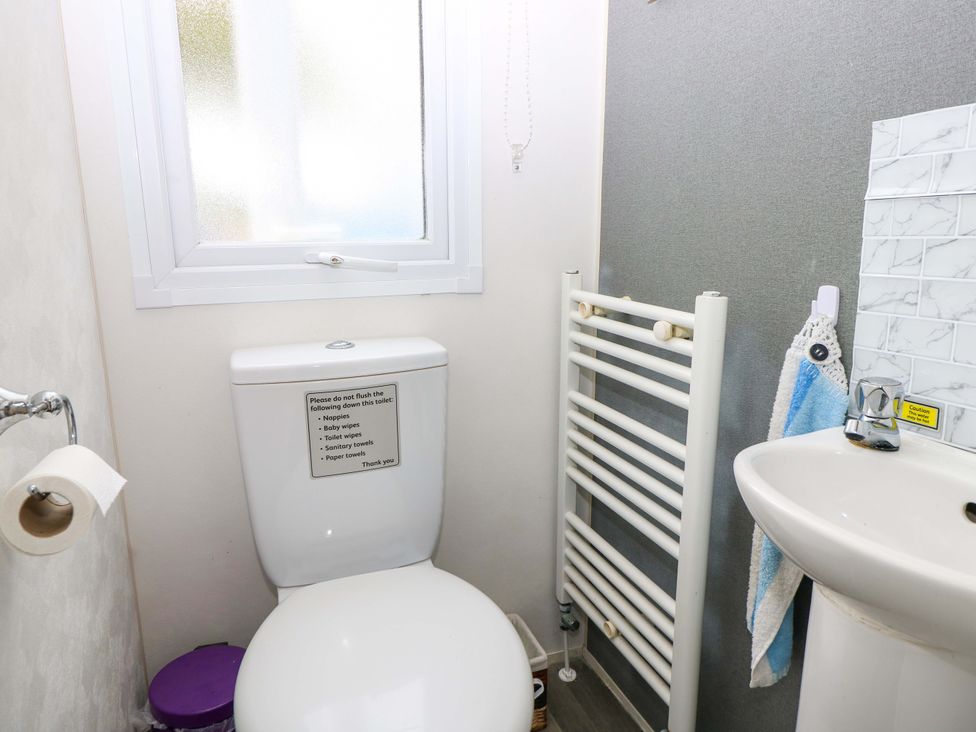 A bathroom with a toilet and sink at Caravan in Cowes