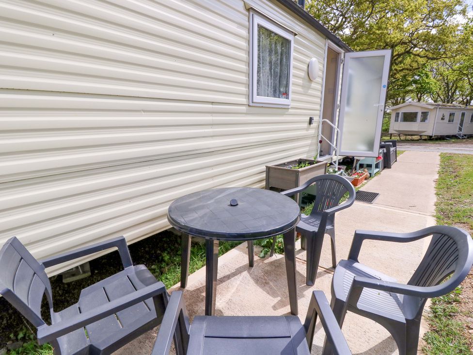 An outdoor seating area with a table and chairs at Caravan in Cowes