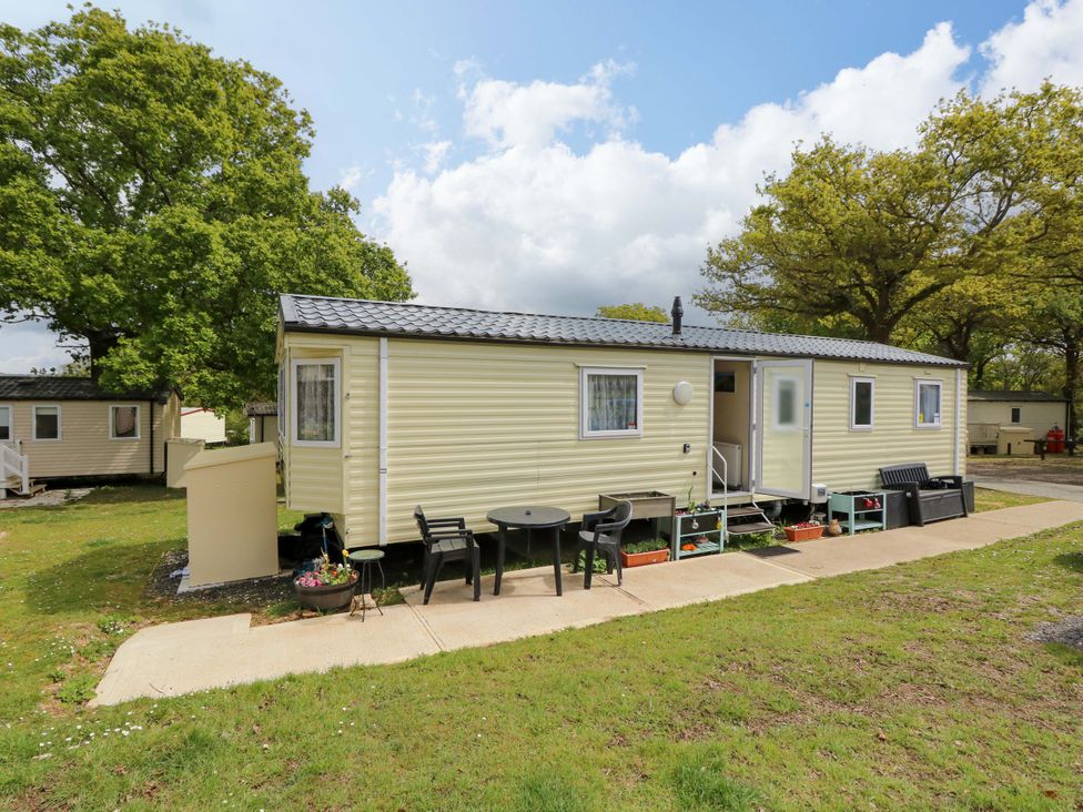 A caravan with a table and chairs outside at Caravan in Cowes