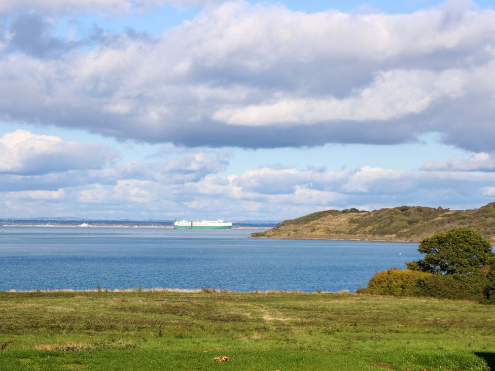 A view of water with a ship in the distance at Caravan in Cowes