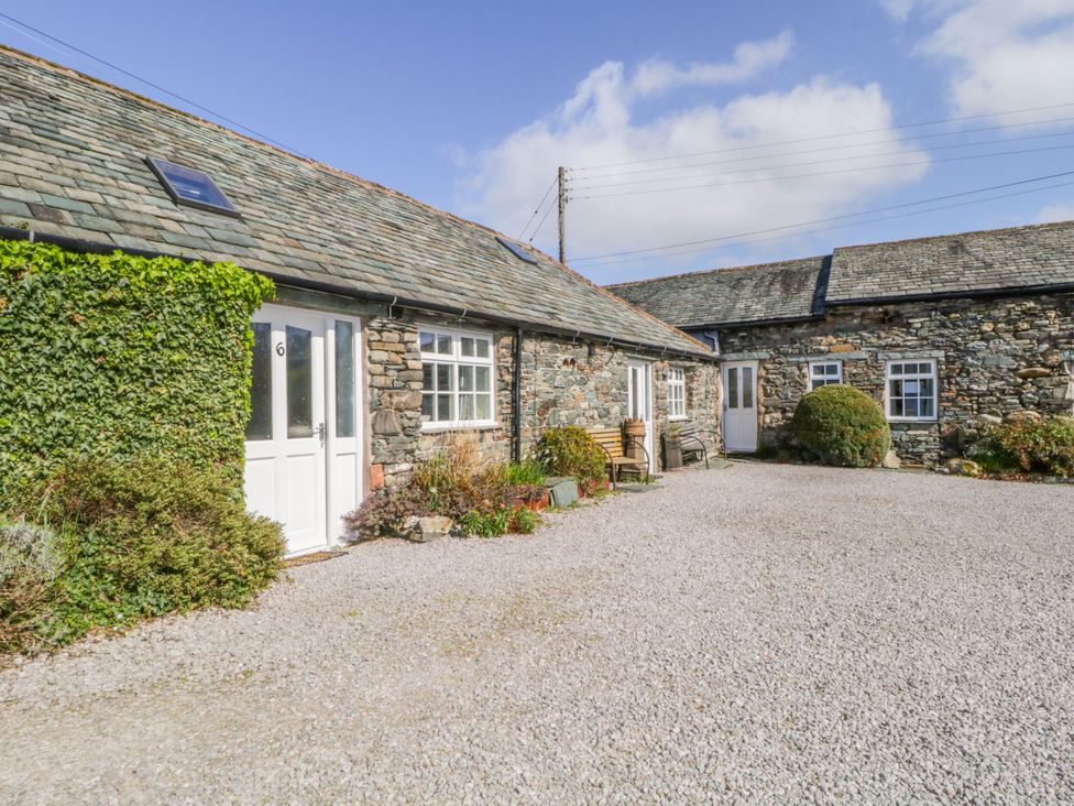 A cottage exterior with a garden and gravel area at Mews Cottage 6 Keswick