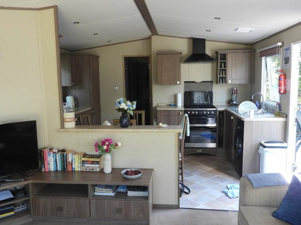 A kitchen with stove and sink at Lifes A Beach in Holt