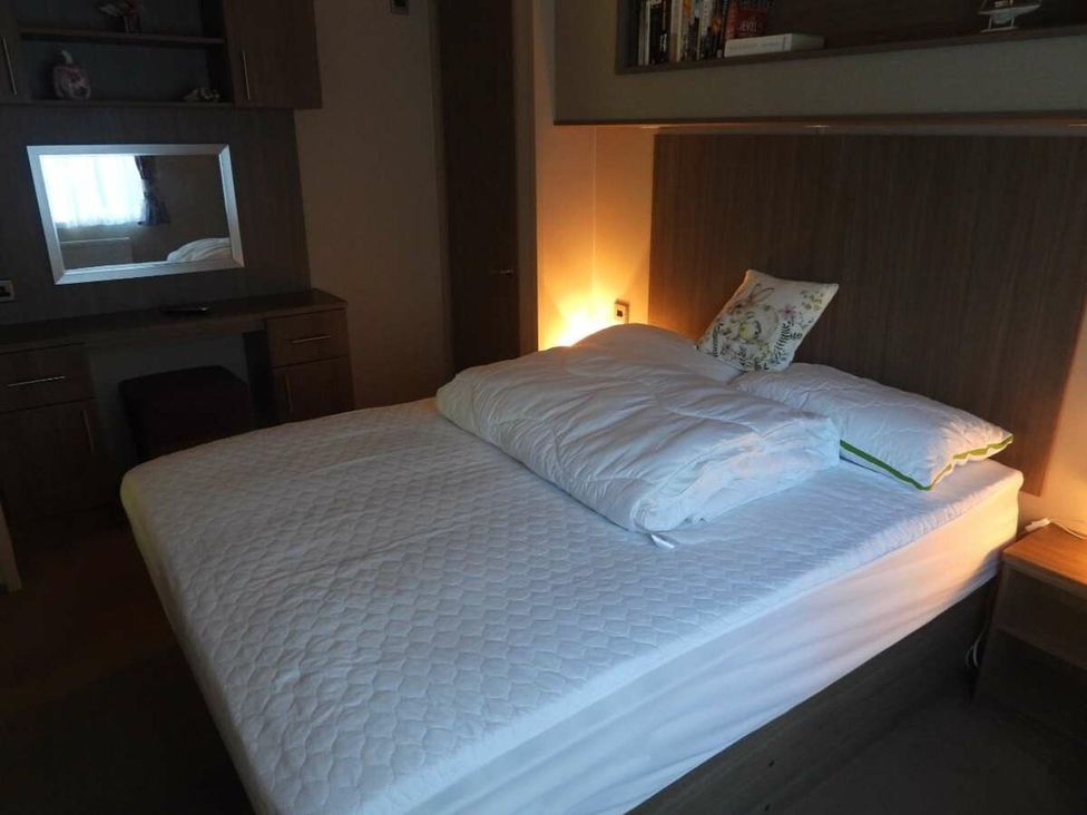 A bedroom with a bed and desk area at Lifes A Beach in Holt