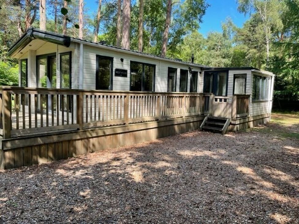 A house with a deck and steps at Living The Dream in Holt