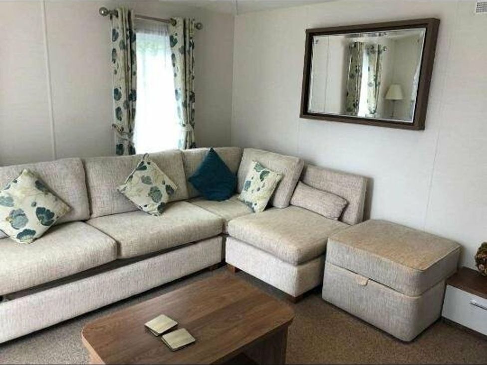 A living room with a sofa and coffee table at Another Day In Paradise Holt