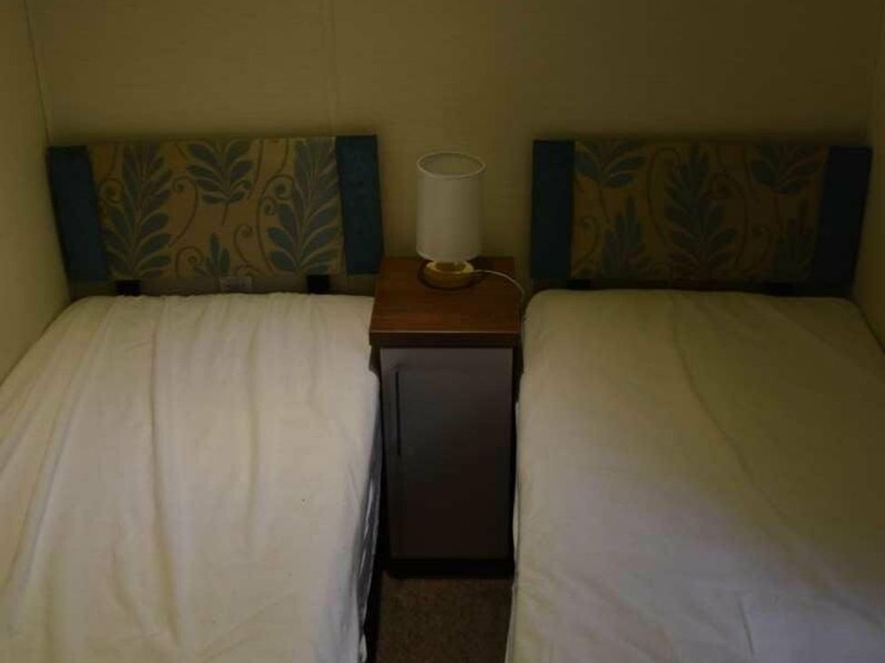 A bedroom with two beds and a lamp at Another Day In Paradise in Holt