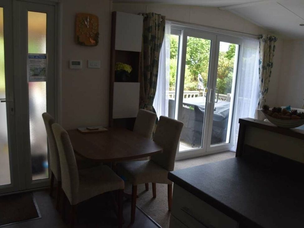 A dining room with a table and chairs at Another Day In Paradise in Holt