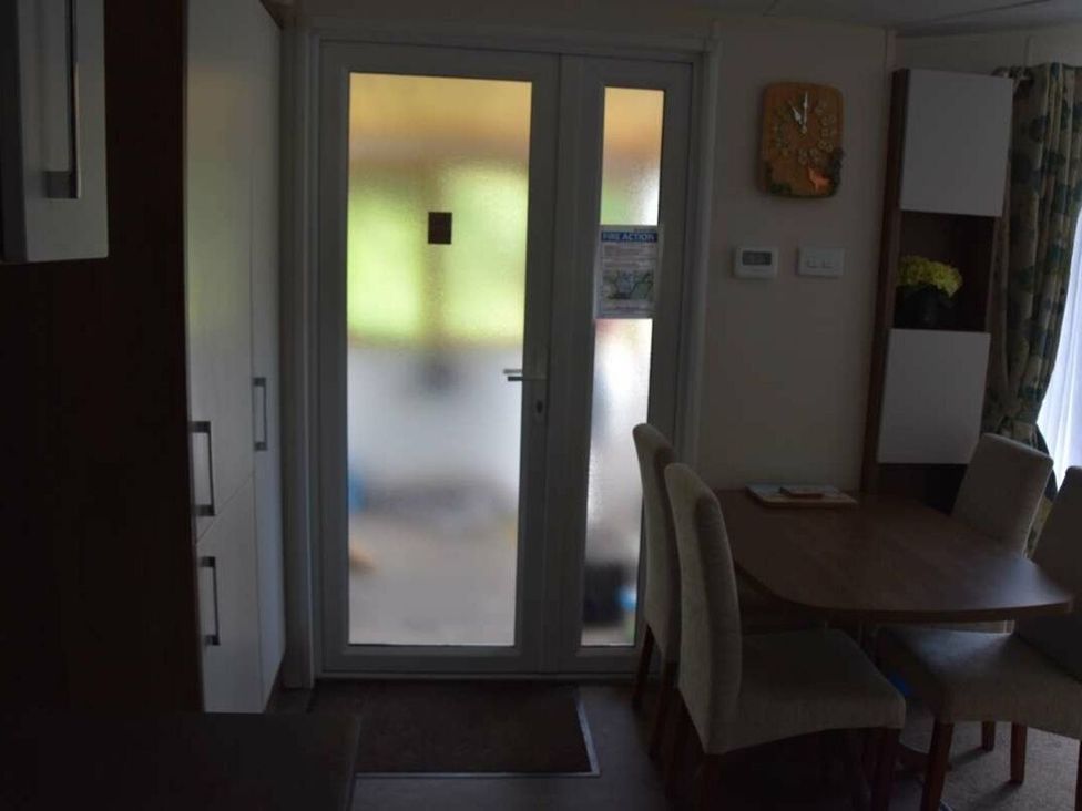 A dining room with a table and chairs at Another Day In Paradise in Holt