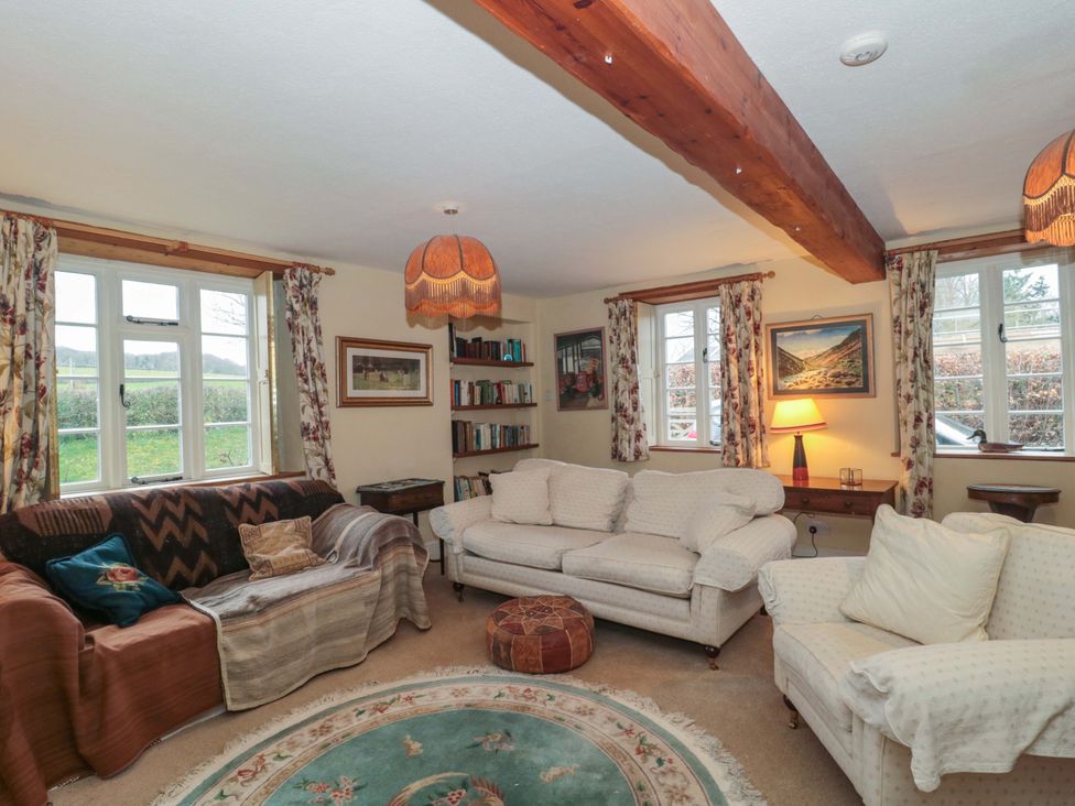 A living room with two sofas and a bookshelves at Tuxwell Lodge Spaxton near Nether Stowey
