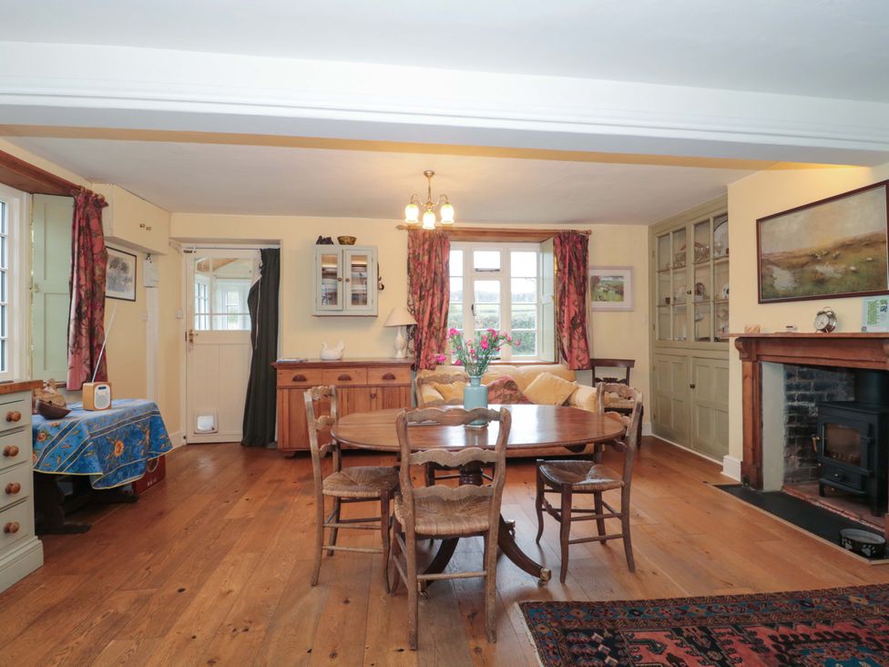 A dining room with a table and chairs at Tuxwell Lodge in Spaxton near Nether Stowey