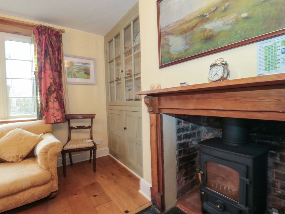 A living room with a sofa and a chair at Tuxwell Lodge Spaxton near Nether Stowey