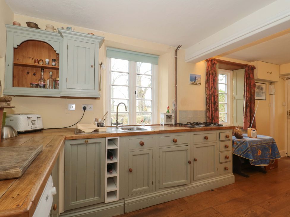 A kitchen with a sink and stove at Tuxwell Lodge in Spaxton near Nether Stowey