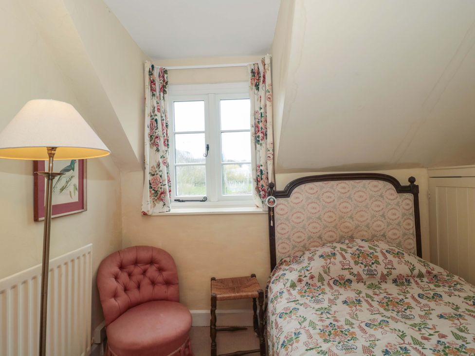 A bedroom with a bed and lamp at Tuxwell Lodge Spaxton near Nether Stowey