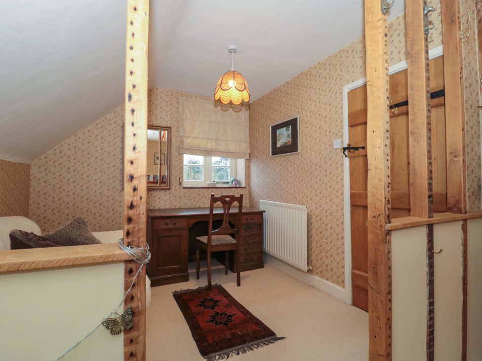 A bedroom with a desk and chair at Tuxwell Lodge Spaxton near Nether Stowey