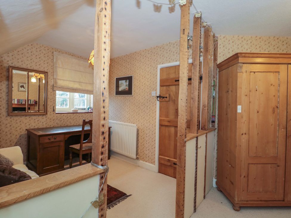 A study area with a desk and chair at Tuxwell Lodge Spaxton near Nether Stowey