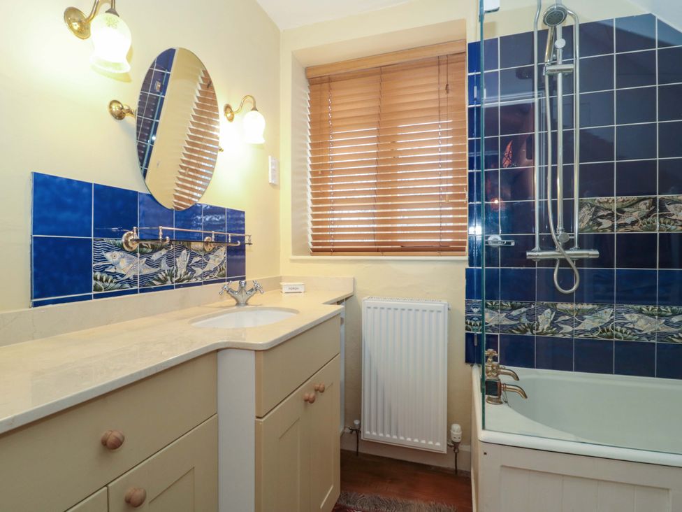 A bathroom with a sink, bathtub, and shower at Tuxwell Lodge in Spaxton near Nether Stowey