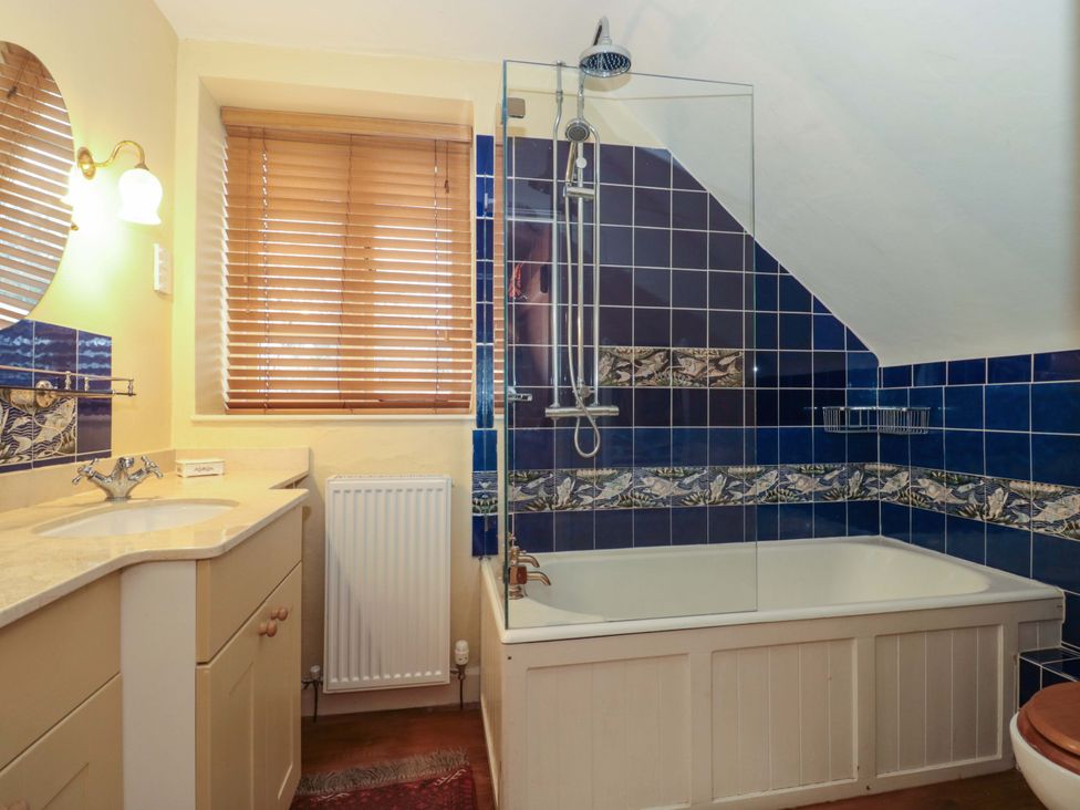 A bathroom with a bathtub and shower at Tuxwell Lodge in Spaxton near Nether Stowey