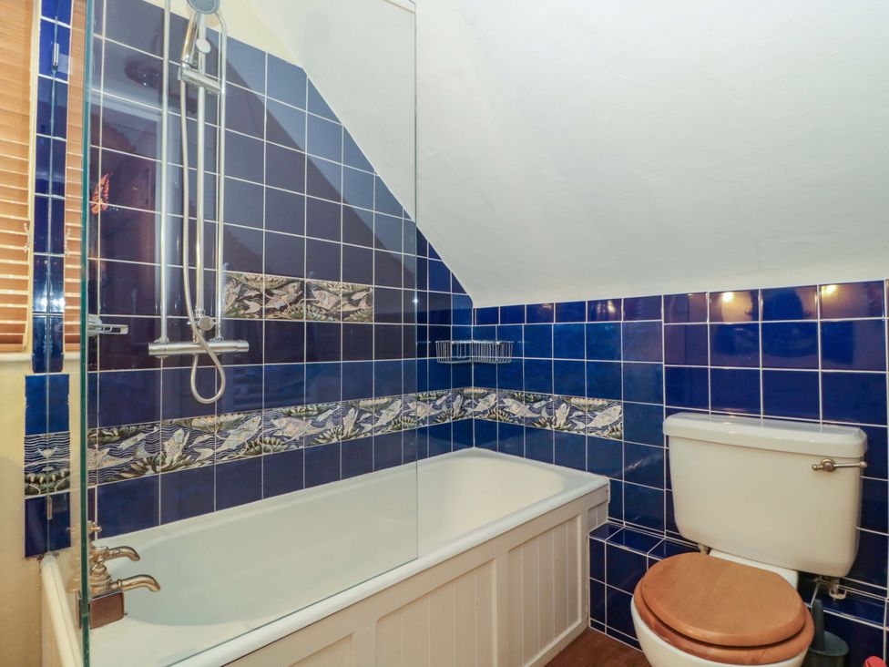 A bathroom with a bathtub and shower at Tuxwell Lodge Spaxton near Nether Stowey