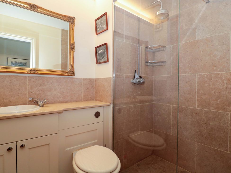 A bathroom with a shower and a toilet at Tuxwell Lodge in Spaxton near Nether Stowey