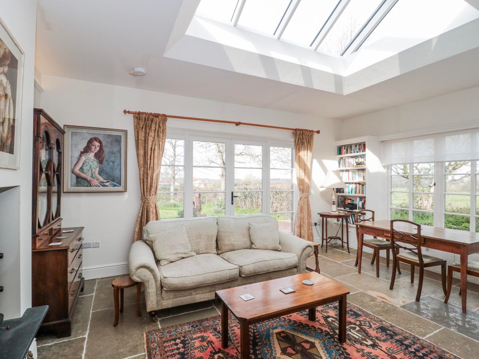 A living room with a sofa and coffee table at Tuxwell Lodge near Nether Stowey