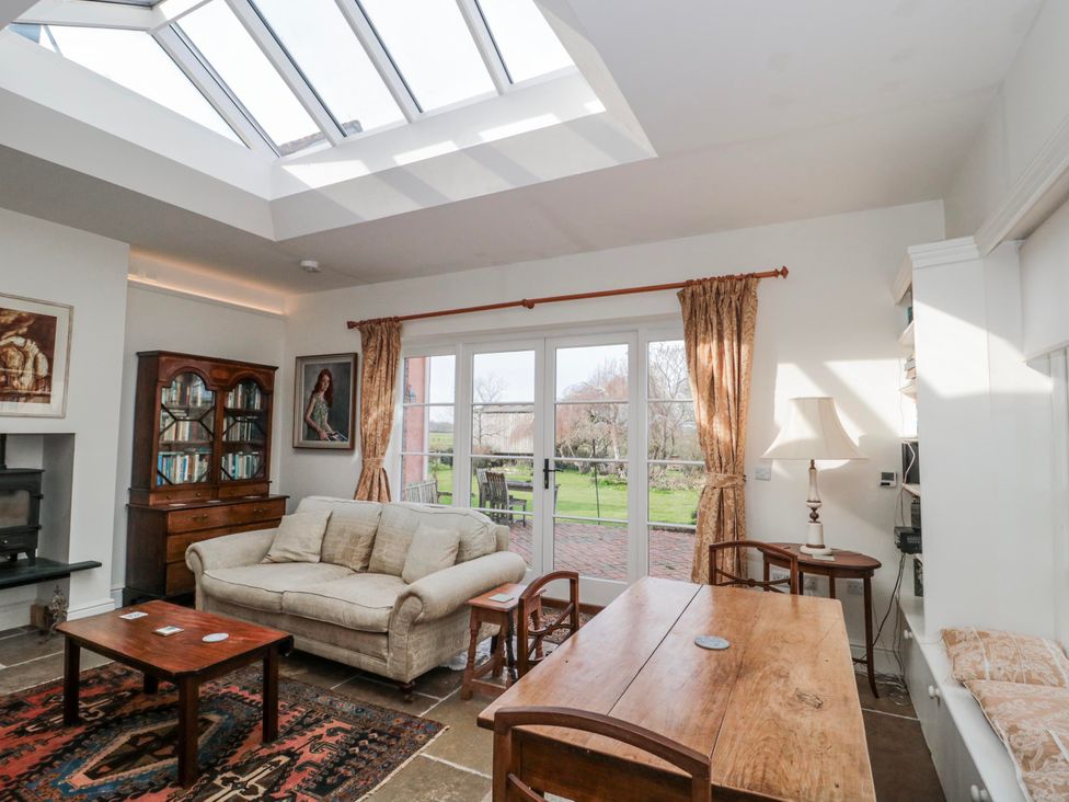 A snug with a sofa and coffee table at Tuxwell Lodge near Nether Stowey