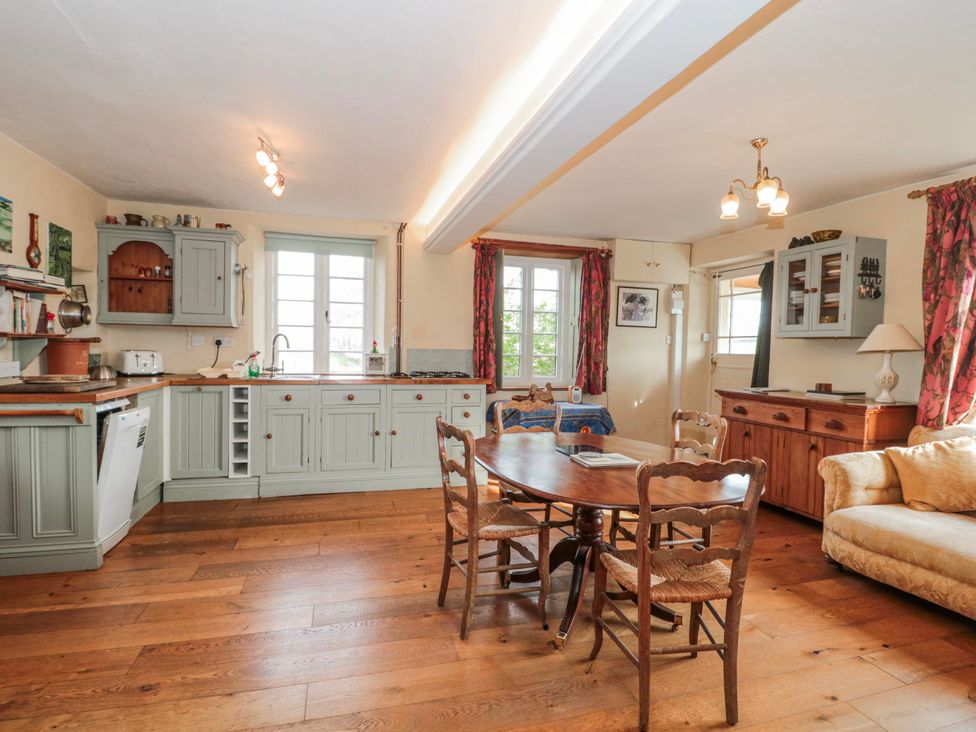 A kitchen with a table and chairs at Tuxwell Lodge near Nether Stowey