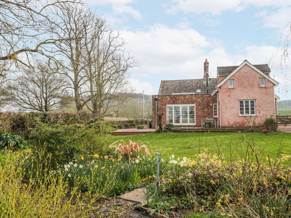 A house with a garden and flowers at Tuxwell Lodge near Nether Stowey