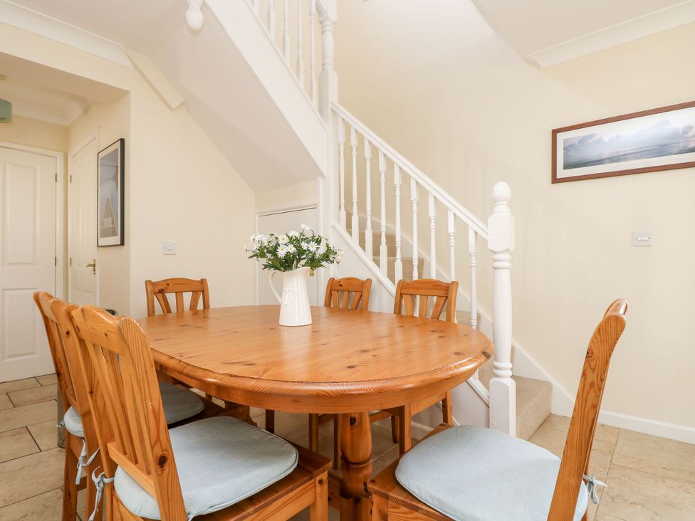 A dining room with a table and chairs at Oak Cottage in Falmouth