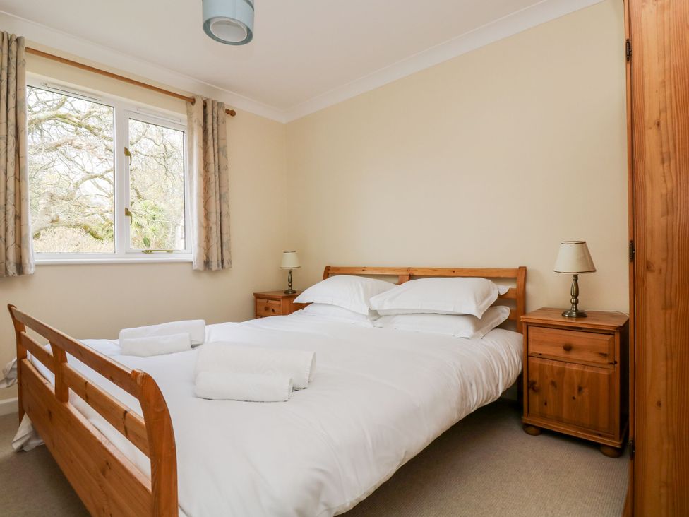 A bedroom with a bed and bedside tables at Oak Cottage in Falmouth