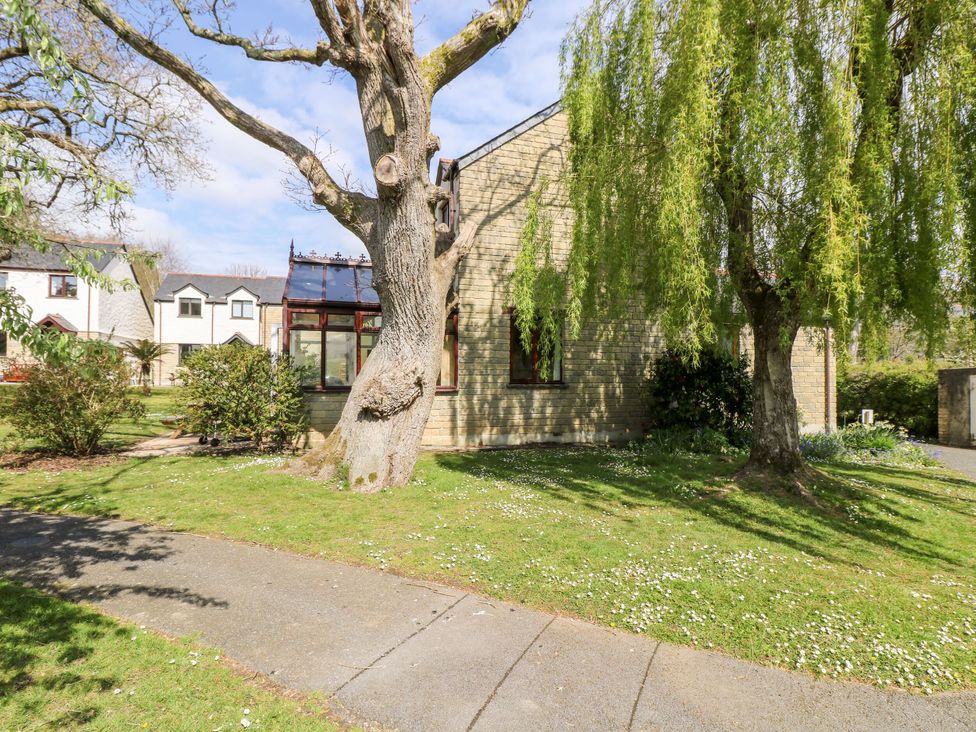 A house with trees and garden area at Oak Cottage in Falmouth