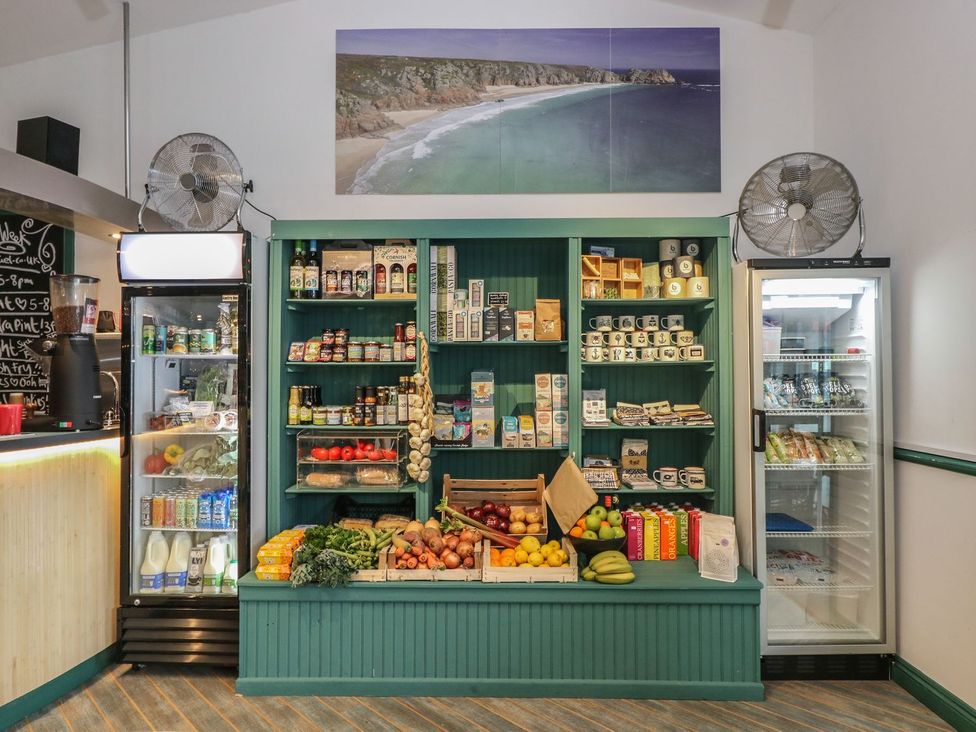 A store displaying shelves of food items and beverages at Oak Cottage in Falmouth