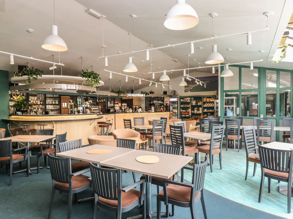 A dining room with tables and chairs at Oak Cottage in Falmouth