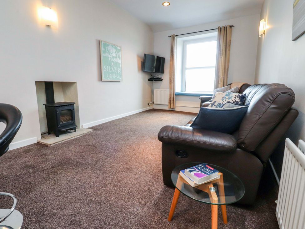 A living room with a sofa and television at Flat 2, Dorstan in Carnforth
