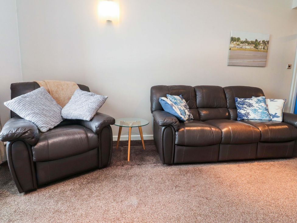 A living room with sofa and armchair at Flat 2, Dorstan in Carnforth