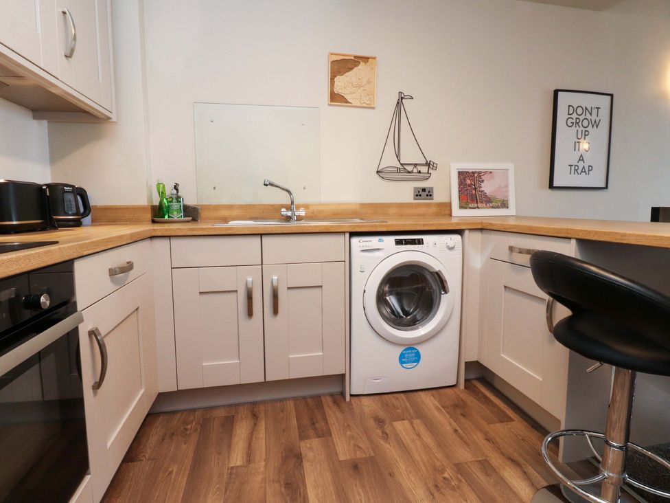 A kitchen with a washing machine and sink at Flat 2, Dorstan in Carnforth
