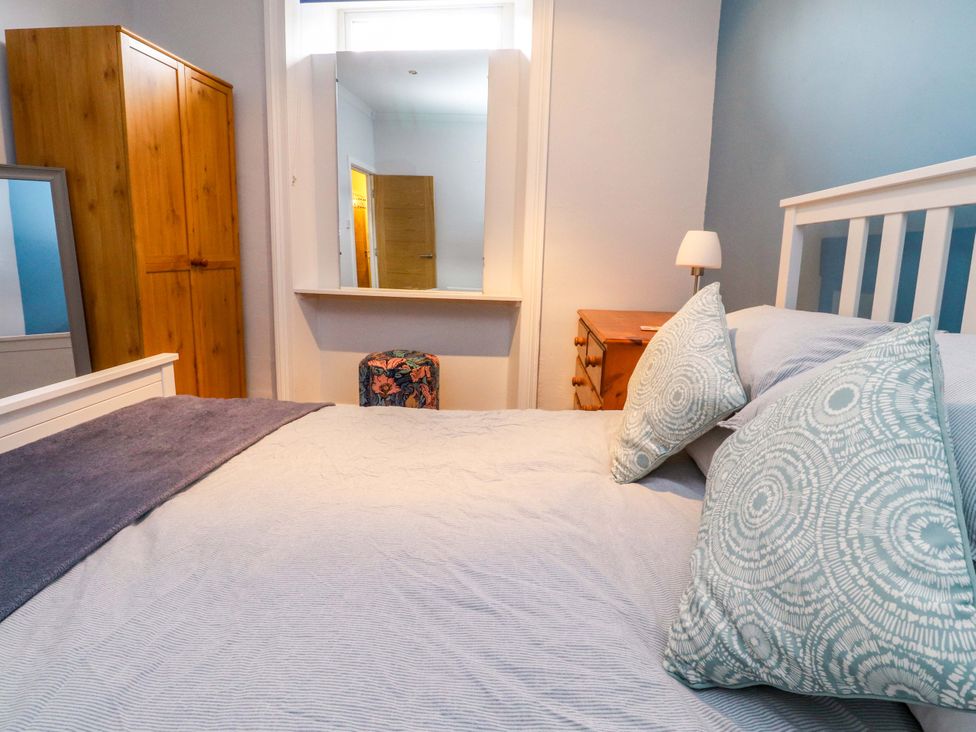 A bedroom with a bed and furniture at Flat 2, Dorstan Carnforth