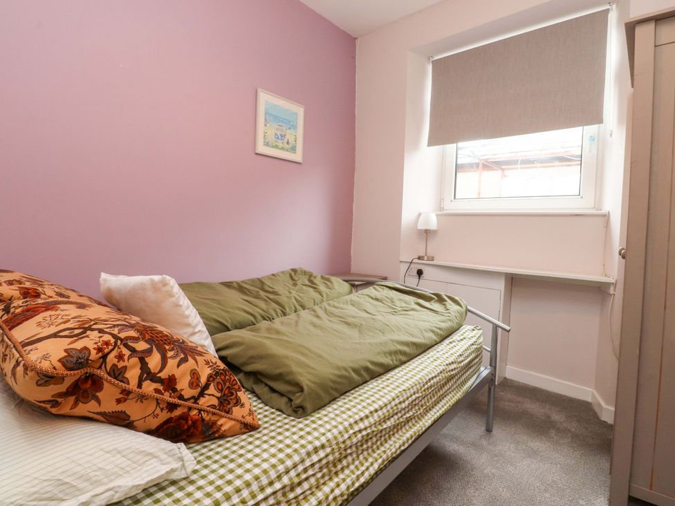 A bedroom with a bed and a window at Flat 2, Dorstan in Carnforth