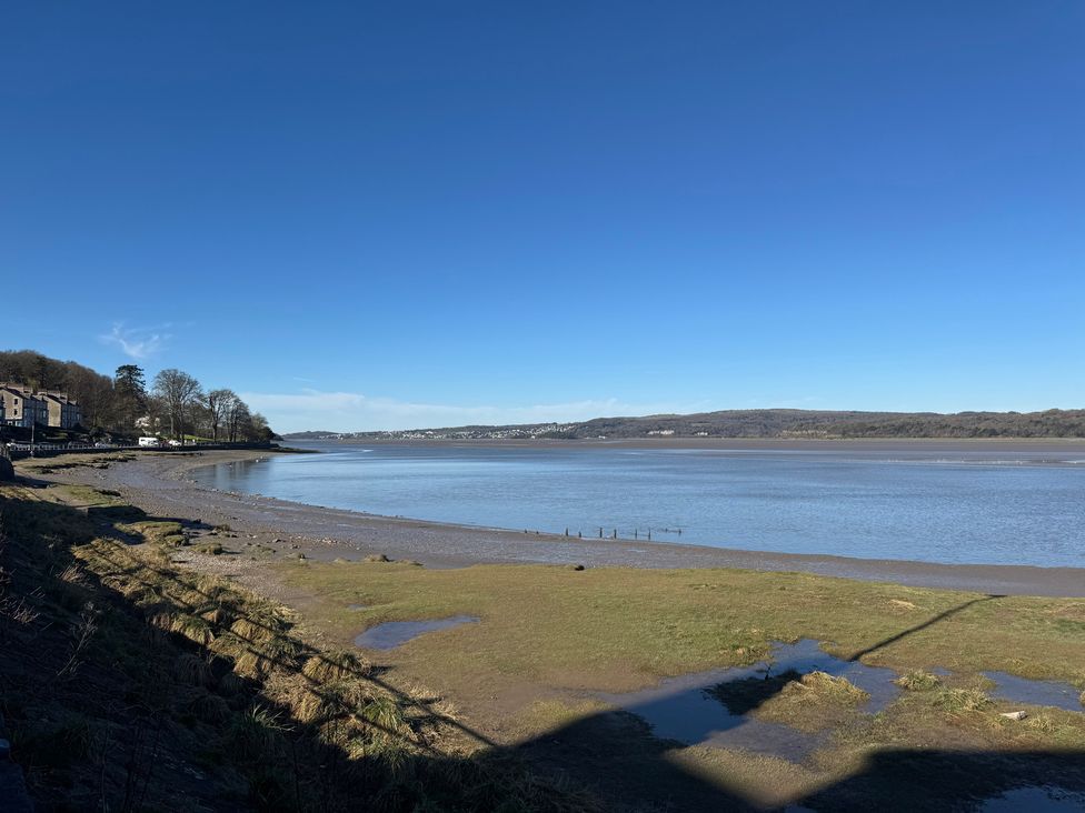 A view of a shoreline with water and trees at Flat 2, Dorstan in Arnside