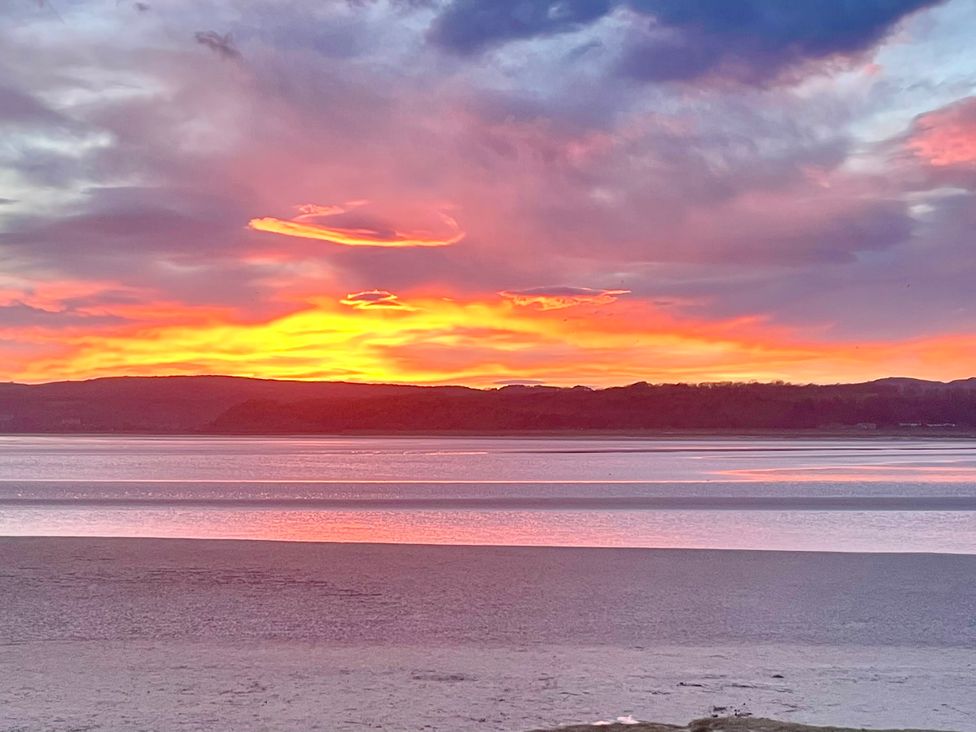 A sunset over water with clouds at Flat 2, Dorstan in Arnside