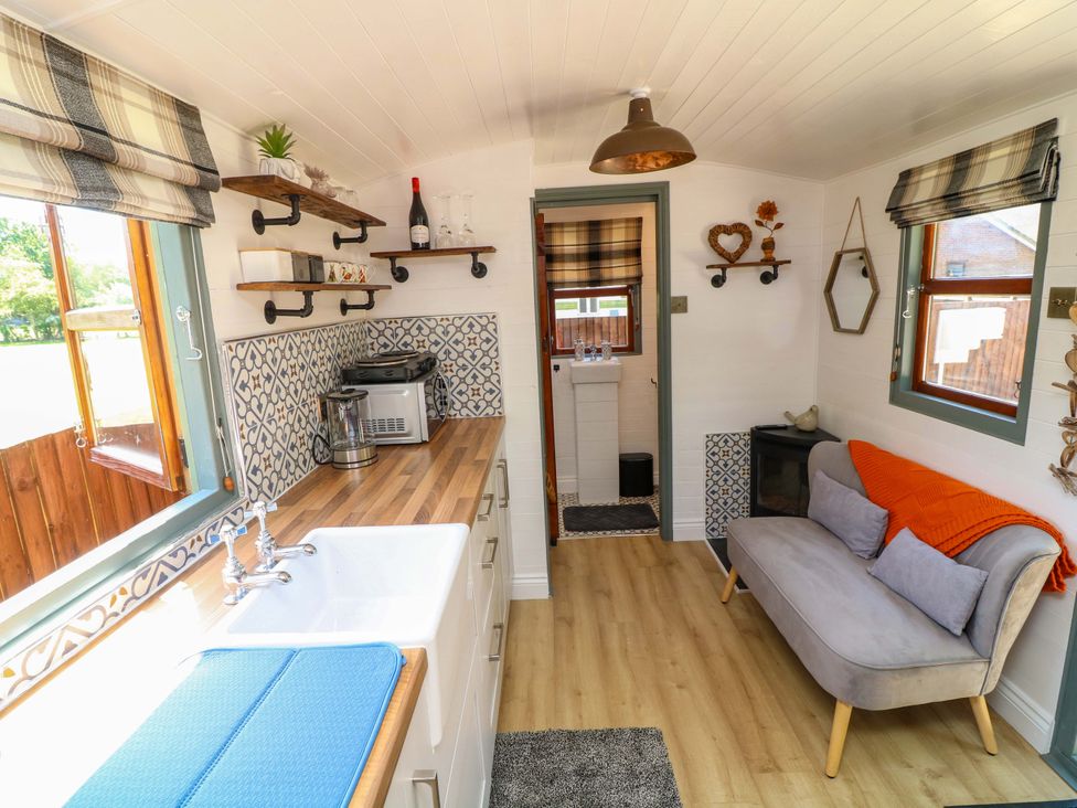 A kitchen with a sink and coffee maker at Shepherds Hut in South Hykeham