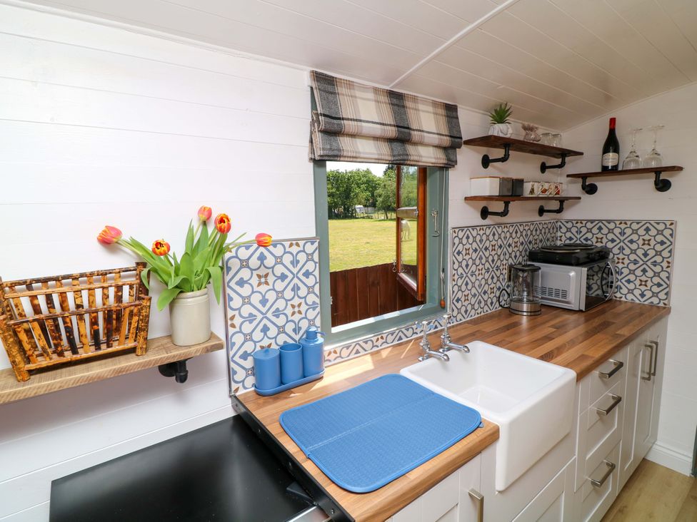 A kitchen with a sink and appliances at Shepherds Hut in South Hykeham