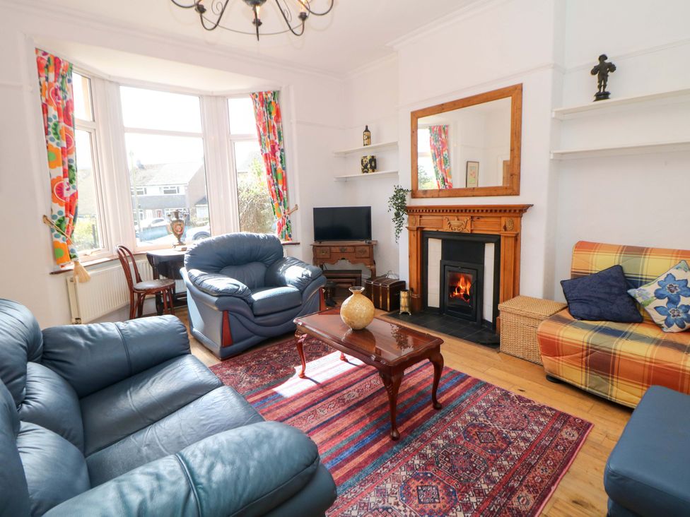 A living room with a sofa and TV at Glenside Lodge in Chapel-En-Le-Frith